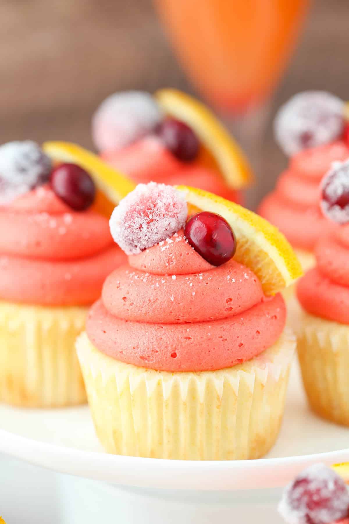 24 Easy & Creative Christmas Cupcakes to Try Right Now 71 24 Easy & Creative Christmas Cupcakes to Try Right Now Cranberry mimosa cupcakes with pink frosting, sugared cranberries, and fresh orange slices