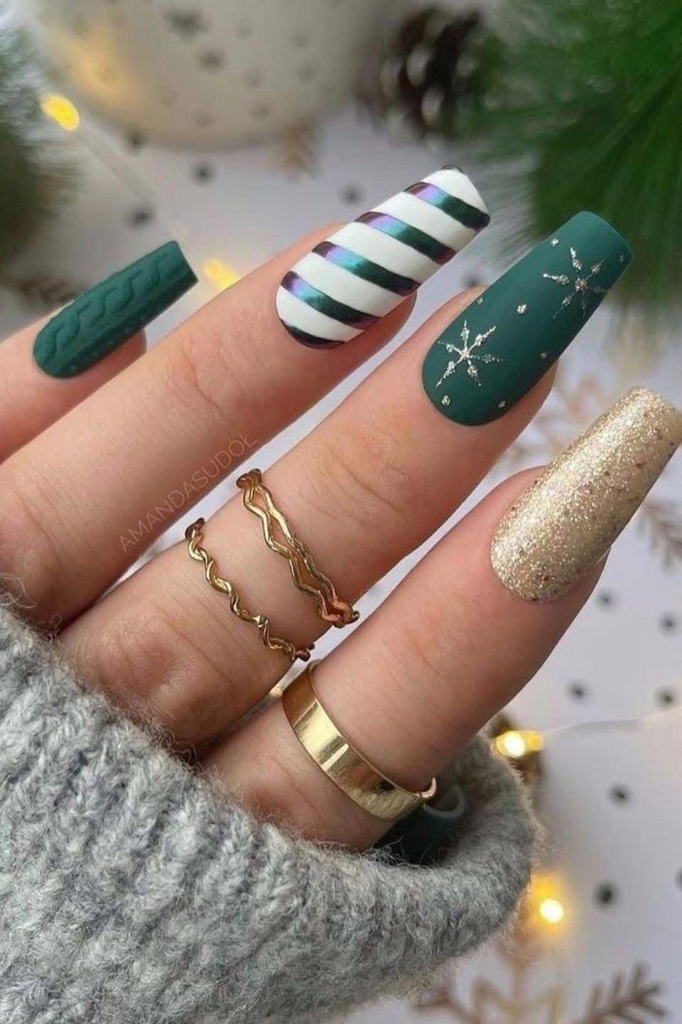 Dark green coffin Christmas nails with sweater texture, striped candy cane accent, silver snowflakes, and gold glitter