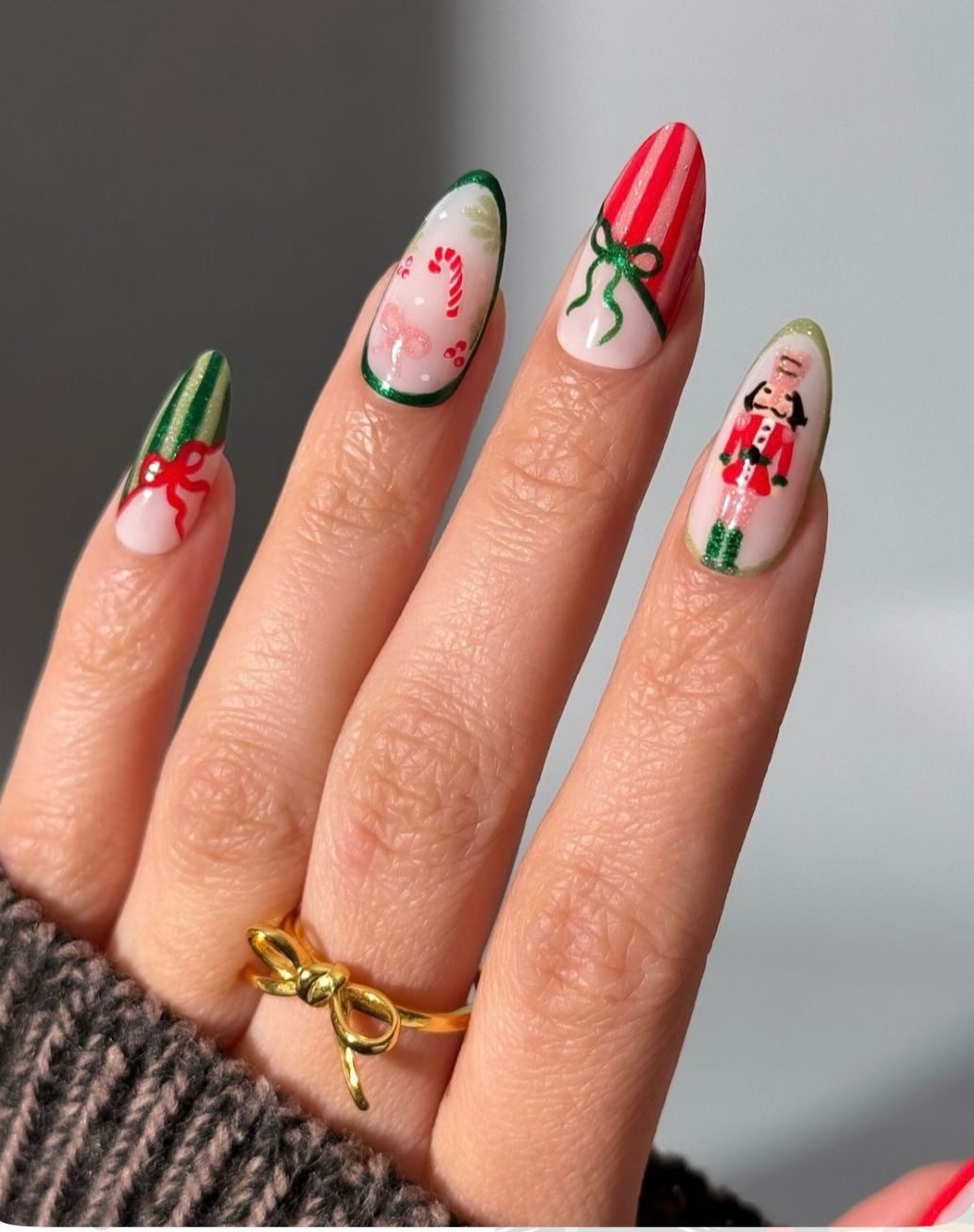 Coral red Christmas coffin nails with white snowflakes, candy cane stripes, and soft nude accents