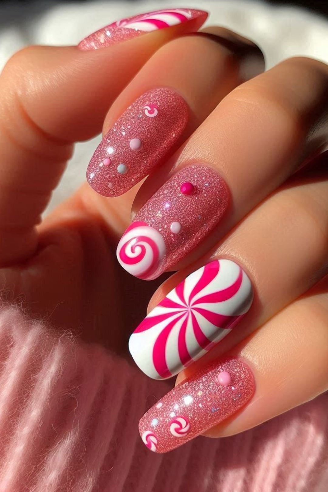 Christmas almond nails with a peppermint swirl, Rudolph reindeer face, green HO HO lettering, and red plaid