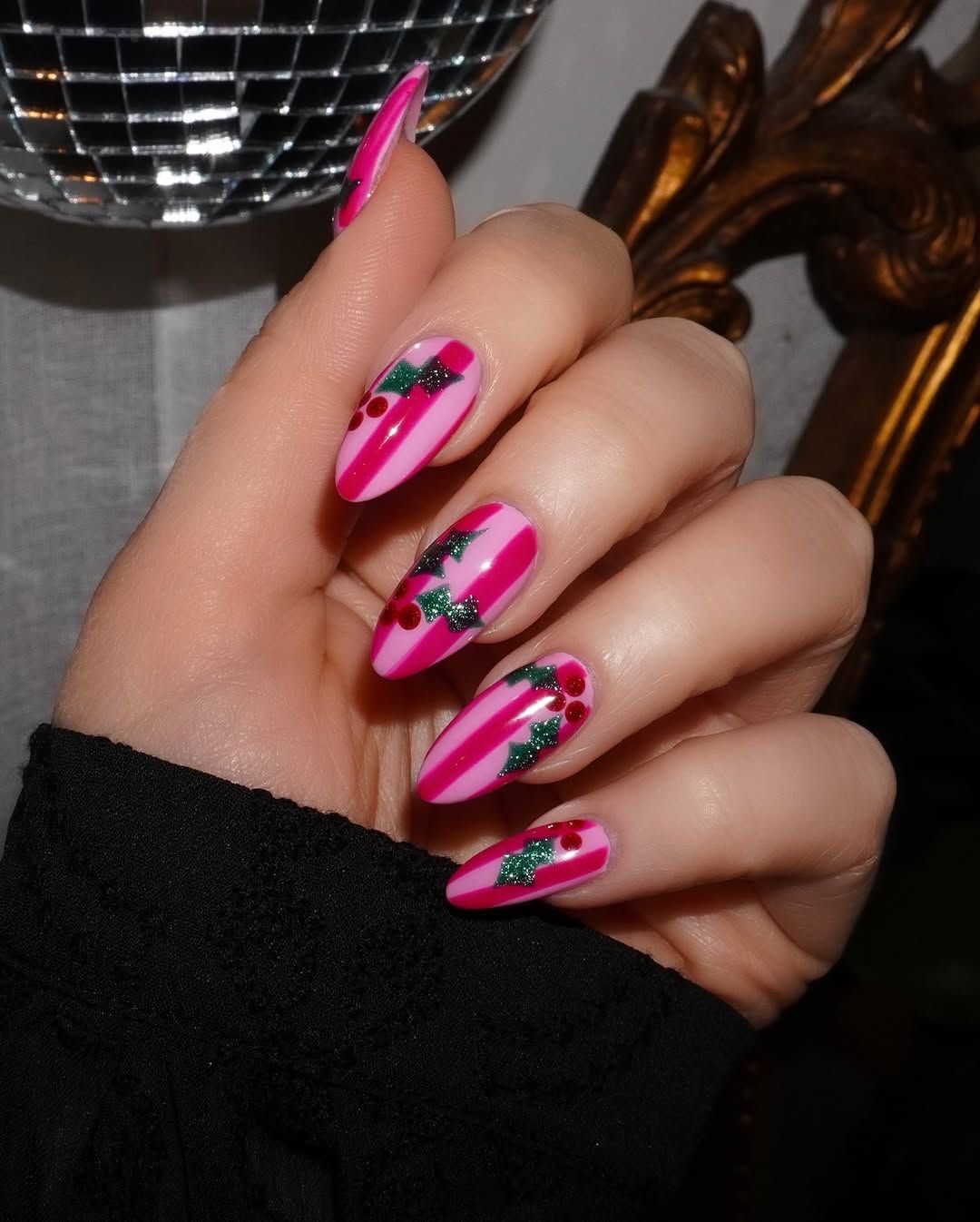 Pink glitter coffin nails with white and hot pink peppermint swirls, tiny candy decorations, and raised dots
