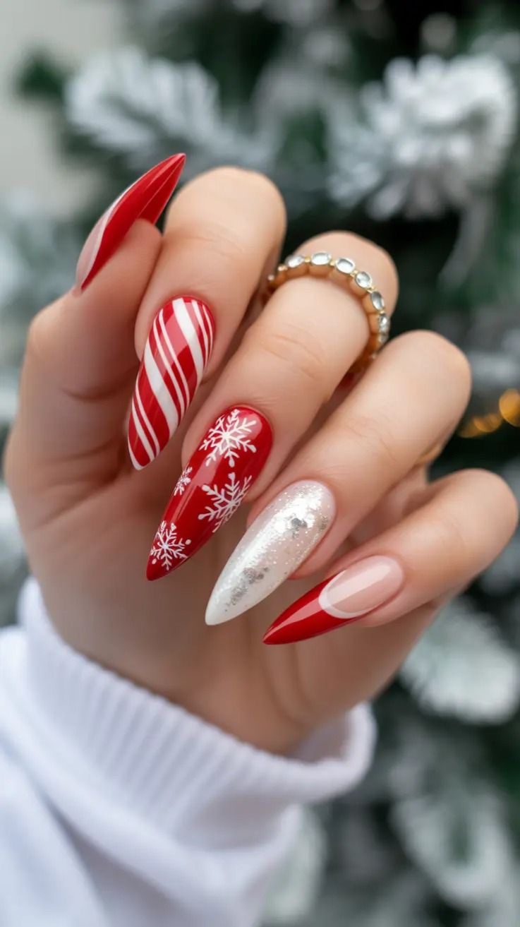 Long red Christmas nails with white snowflakes, candy cane stripes, silver glitter, and red French tips