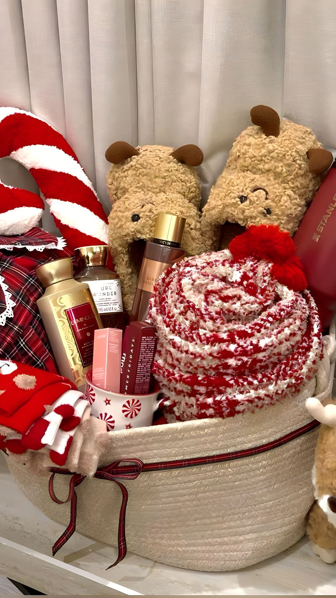 30 Thoughtful Christmas Gift Basket Ideas for Her 61 30 Thoughtful Christmas Gift Basket Ideas for Her Christmas gift basket with reindeer slippers, a red and cream blanket, beauty products and a peppermint mug
