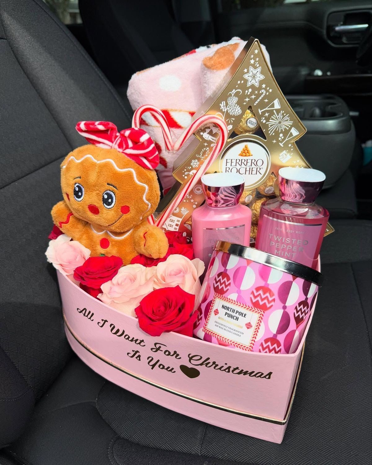 30 Thoughtful Christmas Gift Basket Ideas for Her 73 30 Thoughtful Christmas Gift Basket Ideas for Her Pink heart-shaped Christmas gift box with chocolates, beauty products, a gingerbread plush and red roses