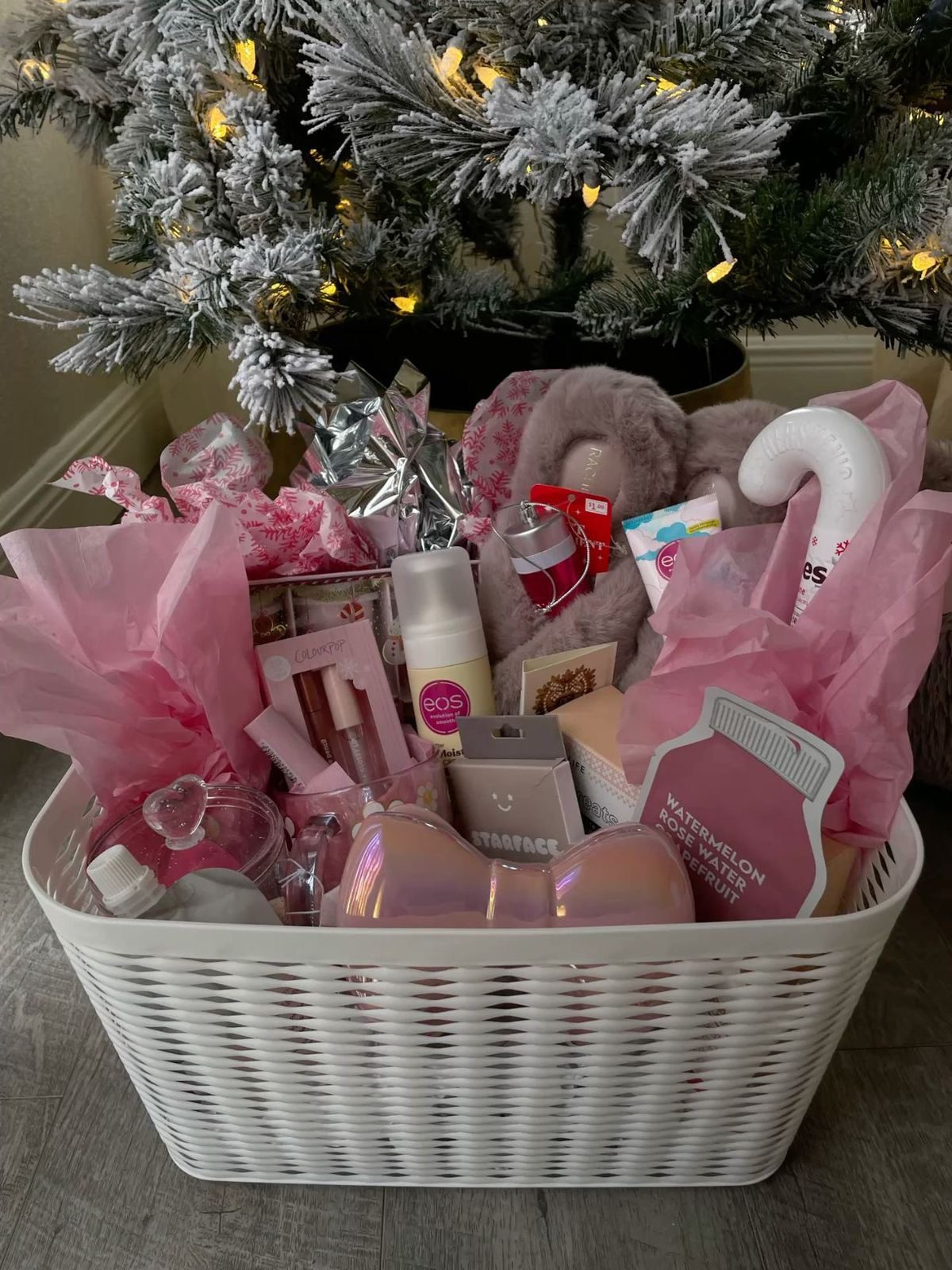 30 Thoughtful Christmas Gift Basket Ideas for Her 62 30 Thoughtful Christmas Gift Basket Ideas for Her White wicker basket filled with pink beauty products, fluffy slippers and pink tissue paper