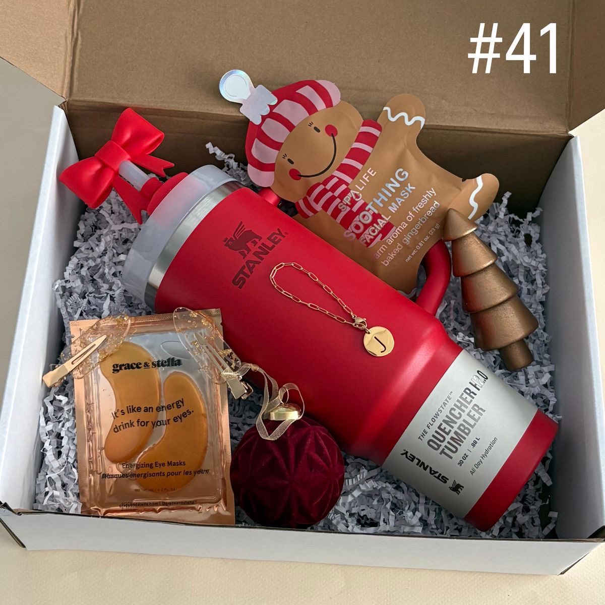30 Thoughtful Christmas Gift Basket Ideas for Her 84 30 Thoughtful Christmas Gift Basket Ideas for Her Christmas gift box with a red insulated tumbler, gingerbread-themed treats, a sachet and red accessories