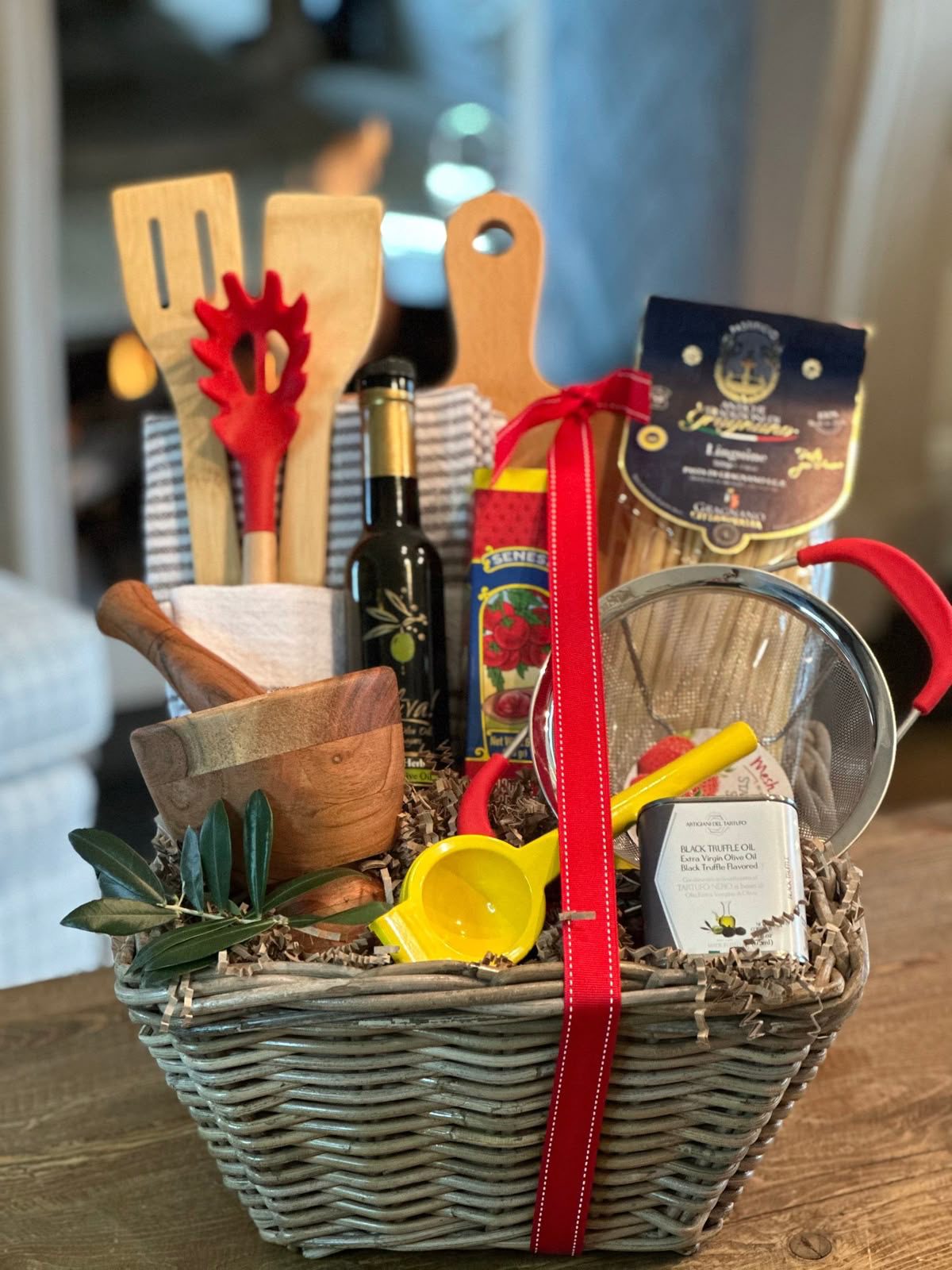 30 Thoughtful Christmas Gift Basket Ideas for Her 87 30 Thoughtful Christmas Gift Basket Ideas for Her Cooking gift basket with wooden utensils, a chopping board, olive oil, a sieve and kitchen accessories