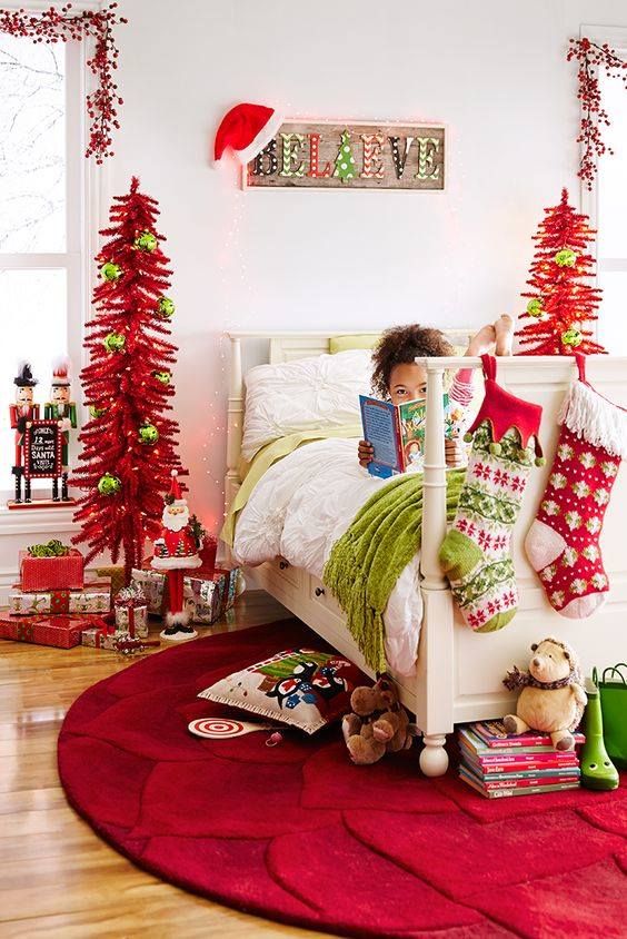 24 Magical Christmas Kids Bedroom Ideas They'll Absolutely Love 49 24 Magical Christmas Kids Bedroom Ideas They'll Absolutely Love Kids Christmas bedroom with red tinsel trees and oversized stockings