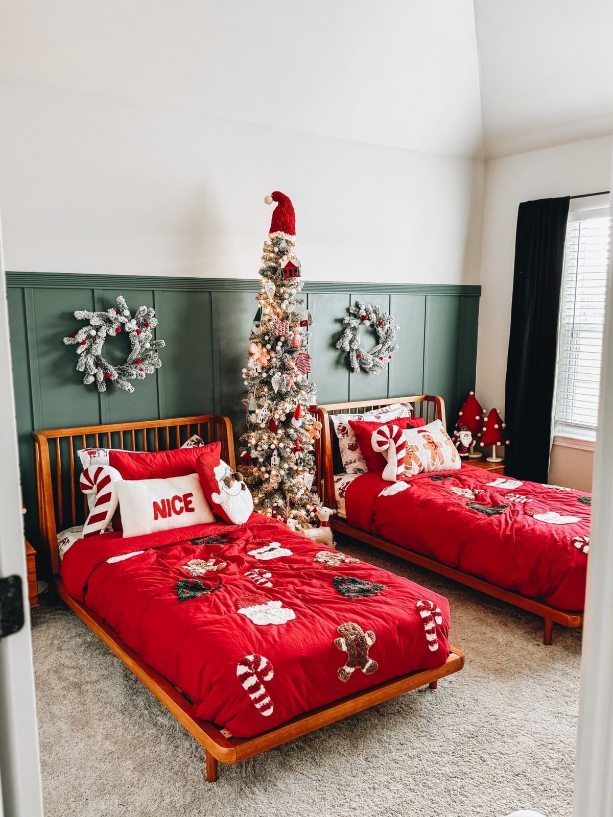 24 Magical Christmas Kids Bedroom Ideas They'll Absolutely Love 53 24 Magical Christmas Kids Bedroom Ideas They'll Absolutely Love Twin kids beds with red Christmas comforters and central decorated tree