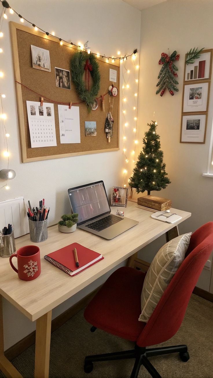 Cosy home office with small Christmas tree, fairy lights, wreath and red desk accessories