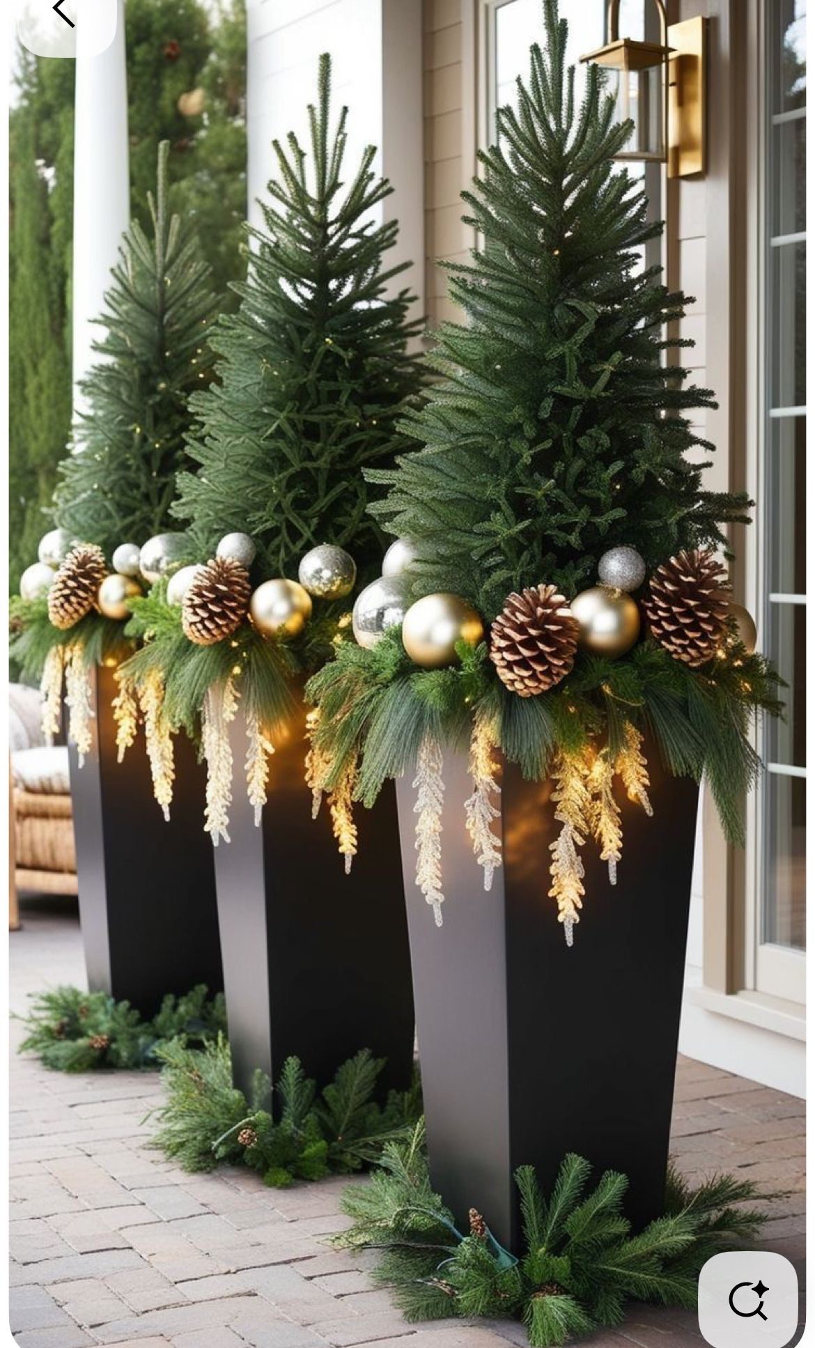 Tall black Christmas porch planters with oversized red and white candy canes, evergreen branches and red ornaments