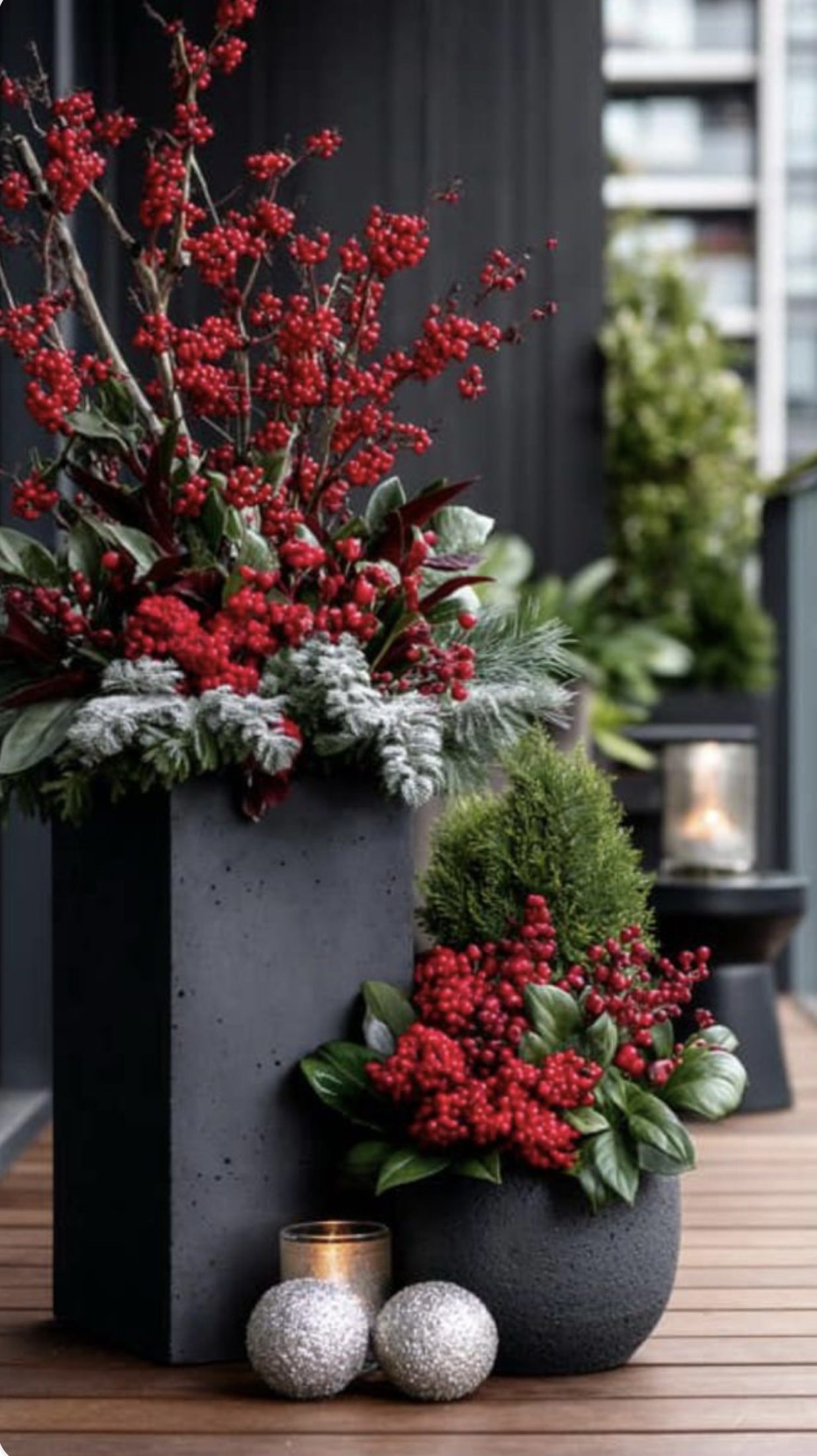 Elegant black Christmas planters decorated with gold and silver ornaments, frosted greenery, winter branches and hanging crystals