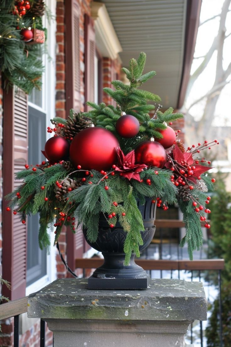 Modern dark grey Christmas planter with red berry branches, frosted pine greenery and winter foliage