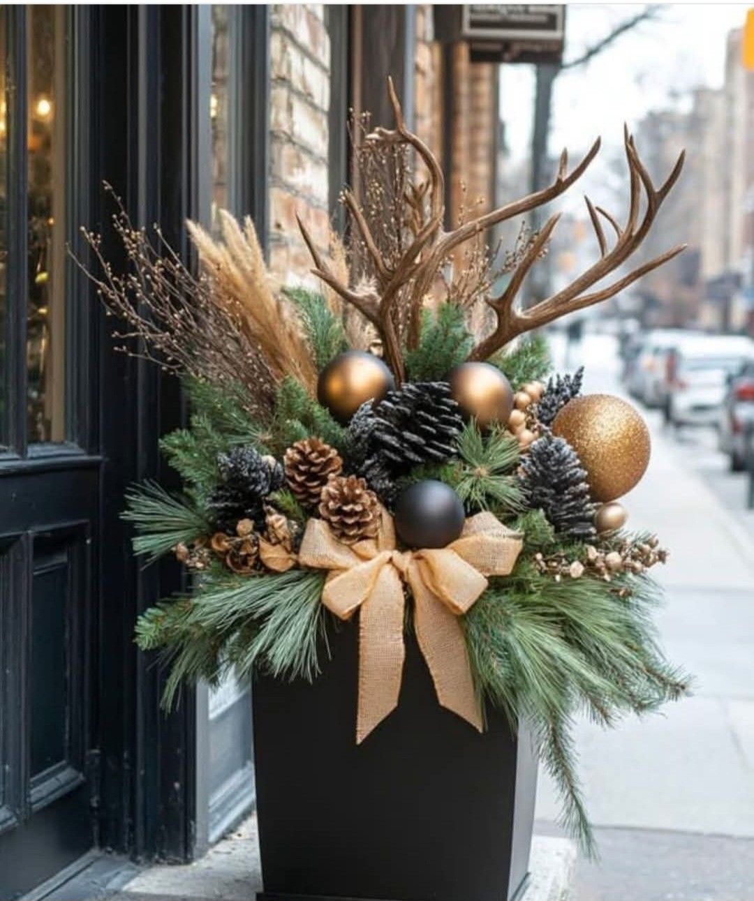 Christmas planter featuring a small evergreen tree surrounded by winter foliage and seasonal greenery