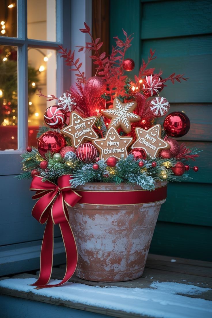 Gingerbread-themed Christmas planter with red ornaments, gingerbread stars, snowflakes and festive ribbon