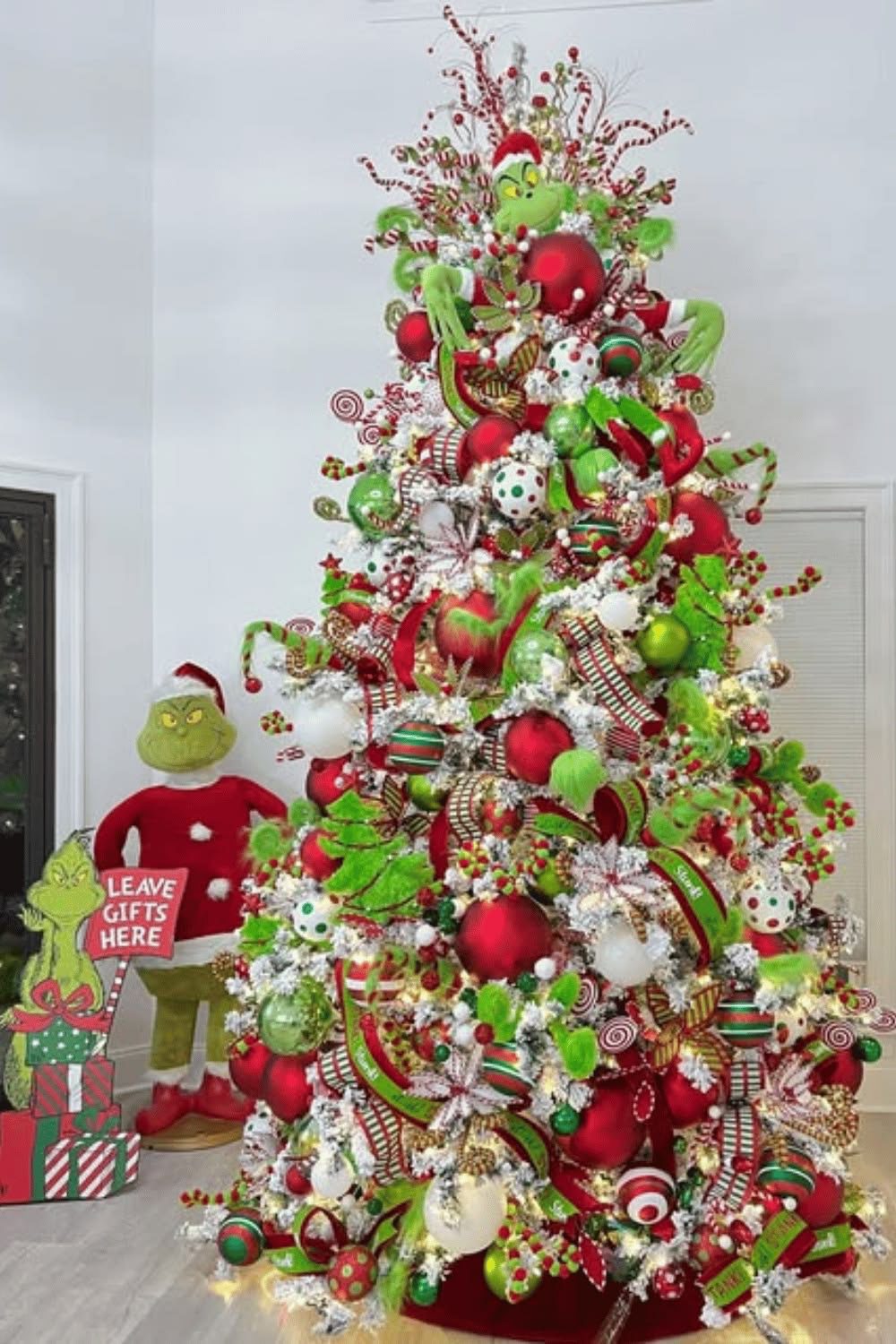 24 Fun Grinch Christmas Tree Ideas You'll Love 49 24 Fun Grinch Christmas Tree Ideas You'll Love Whimsical Grinch Christmas tree with candy cane sprays and red and green ornaments
