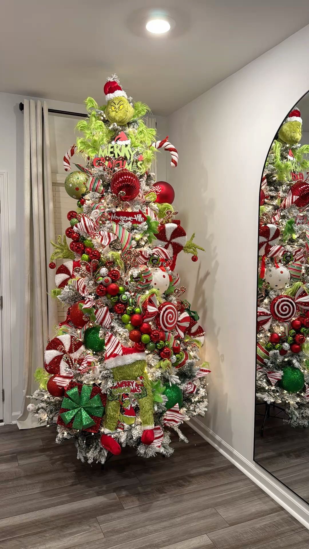 24 Fun Grinch Christmas Tree Ideas You'll Love 64 24 Fun Grinch Christmas Tree Ideas You'll Love Grinch Christmas tree with candy cane swirls, red and green baubles and furry Grinch legs