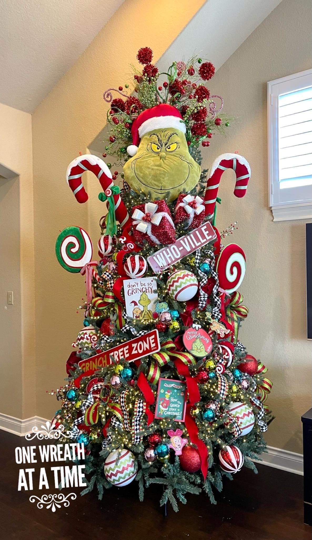 24 Fun Grinch Christmas Tree Ideas You'll Love 70 24 Fun Grinch Christmas Tree Ideas You'll Love Grinch Christmas tree with giant Grinch face, candy cane decorations and Whoville signs