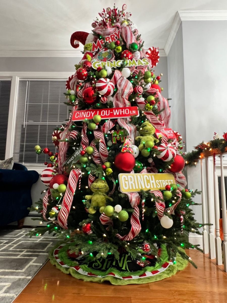 24 Fun Grinch Christmas Tree Ideas You'll Love 71 24 Fun Grinch Christmas Tree Ideas You'll Love Grinchmas Christmas tree with candy stripe ribbons, Grinch Street sign and character ornaments