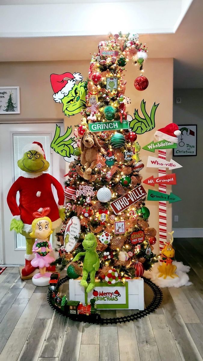 24 Fun Grinch Christmas Tree Ideas You'll Love 72 24 Fun Grinch Christmas Tree Ideas You'll Love Grinch Christmas tree with Whoville signposts, Grinch figures and a Christmas train