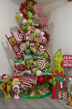 24 Fun Grinch Christmas Tree Ideas You'll Love 53 24 Fun Grinch Christmas Tree Ideas You'll Love Small Grinch Christmas tree with Whoville signs, peppermint decorations and Grinch figures