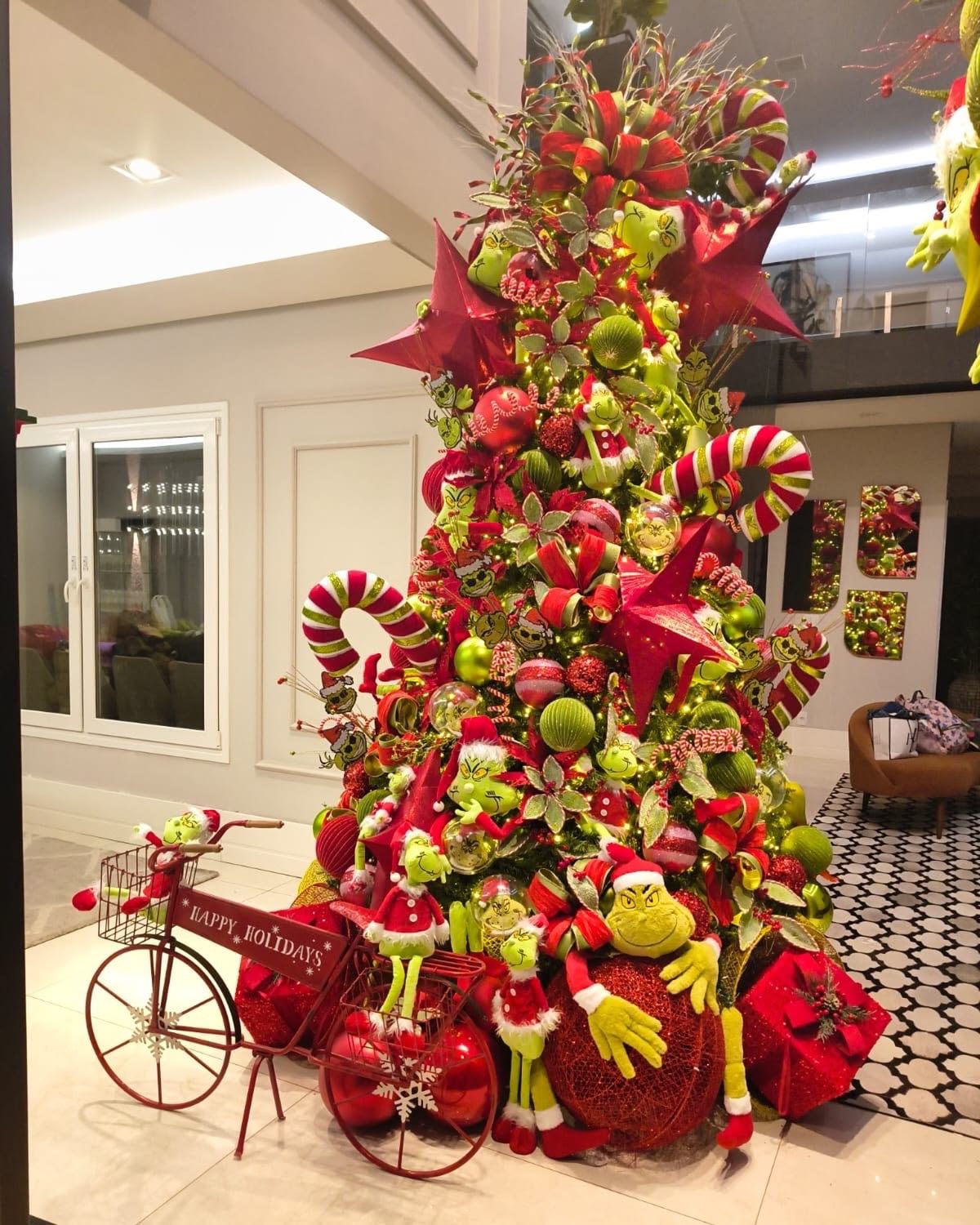 24 Fun Grinch Christmas Tree Ideas You'll Love 55 24 Fun Grinch Christmas Tree Ideas You'll Love Extravagant Grinch Christmas tree with red stars, giant candy canes and character decorations