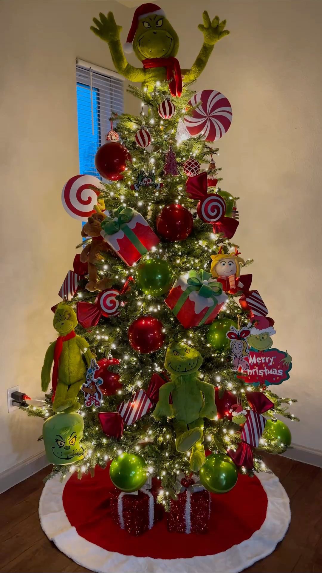 24 Fun Grinch Christmas Tree Ideas You'll Love 56 24 Fun Grinch Christmas Tree Ideas You'll Love Grinch Christmas tree with plush Grinch characters, giant lollipops and red and green baubles