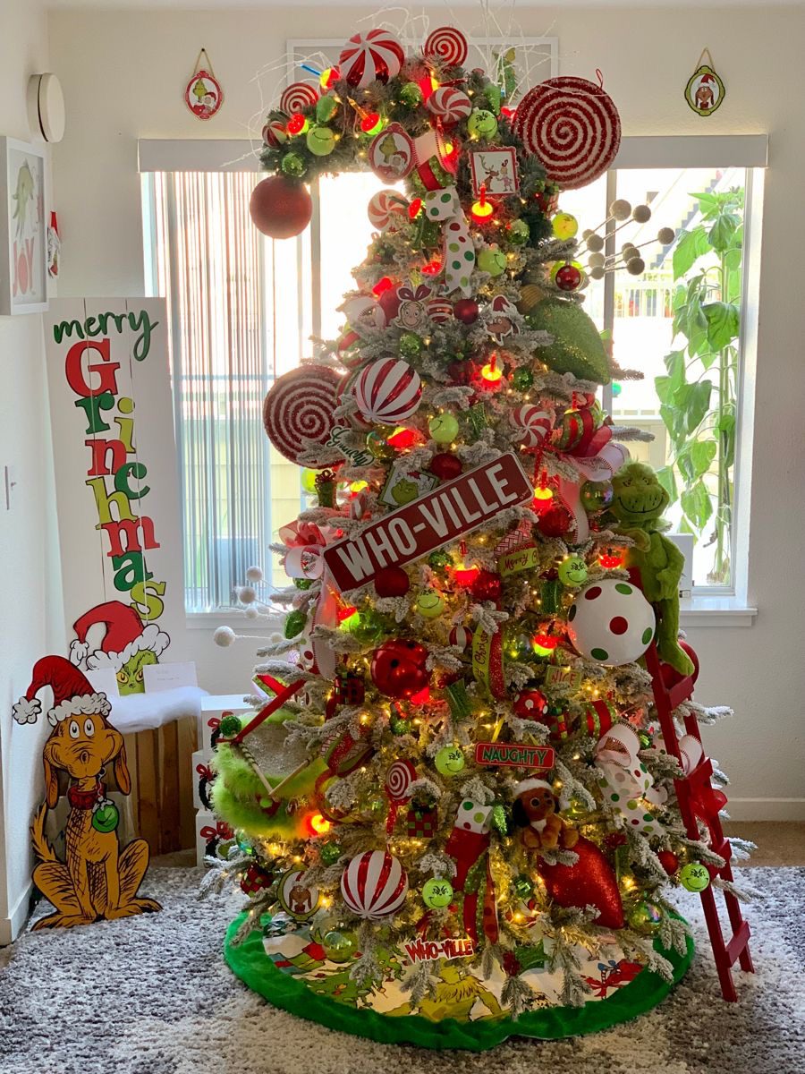 24 Fun Grinch Christmas Tree Ideas You'll Love 57 24 Fun Grinch Christmas Tree Ideas You'll Love Snowy Grinch Christmas tree with a Who-Ville sign, peppermint ornaments and festive lights